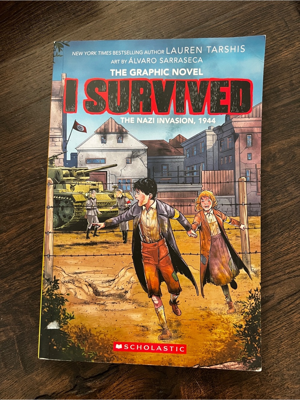 Scholastic Graphic Novel with Blue, Red and Yellow Cover Art